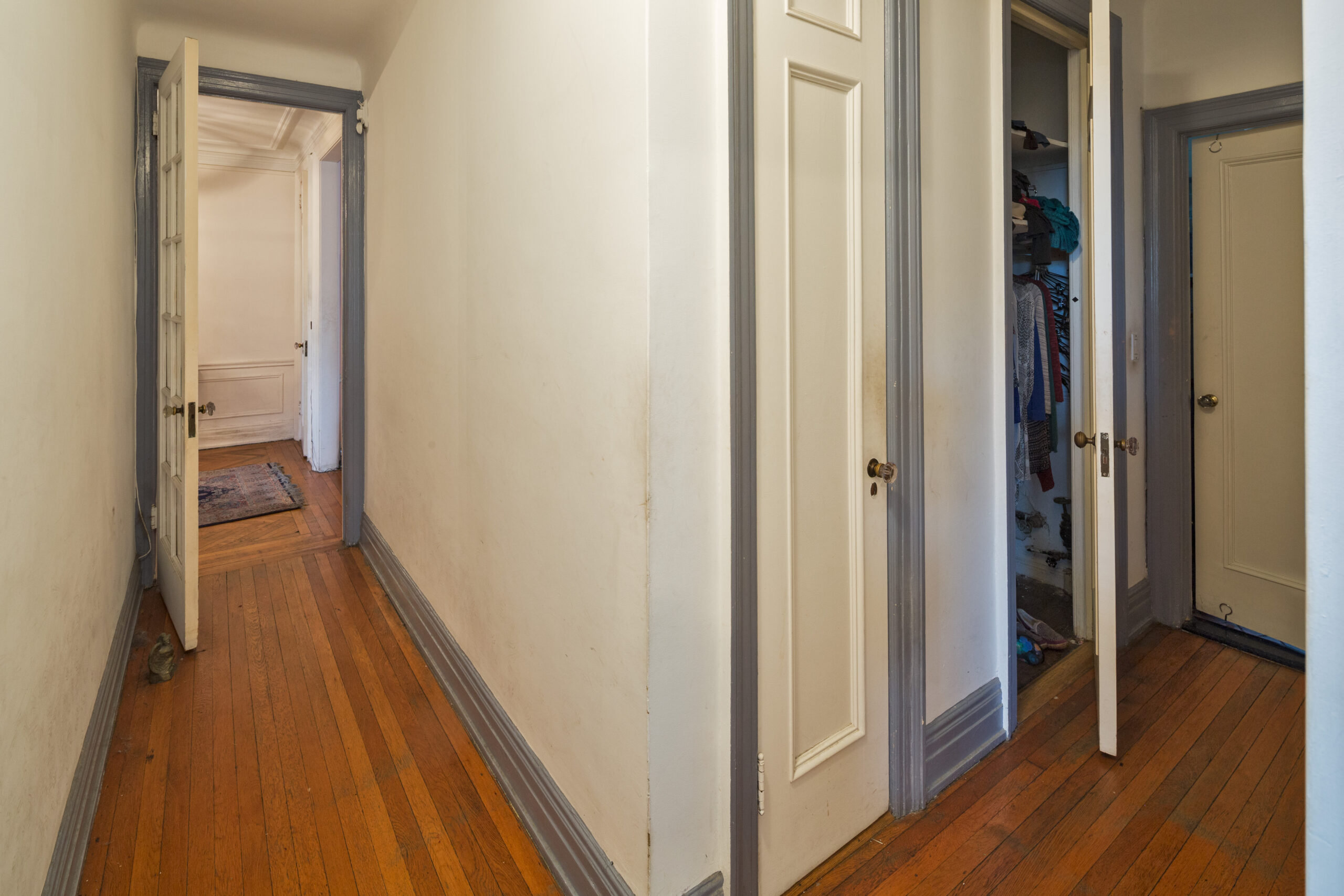 BEFORE Prewar apartments typically have long narrow corridors, wide closets with narrow doors, and frequently a closet occupies awkward spaces Before: In a narrow passage, a plaster wall turns a corner and connects The Foyer and two small closets