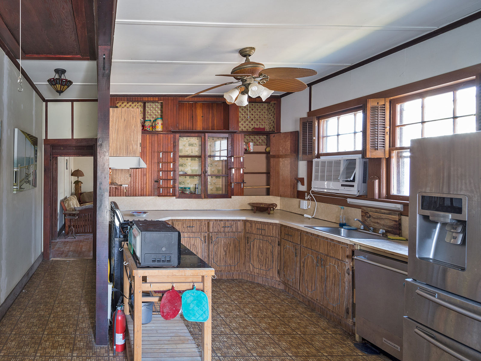 Kitchen Before: A room with limited counter space, limited storage, and a small window; it is isolated from the rest of the house