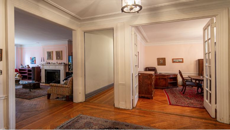 3 doorways opening onto a living room, corridor, and dining room before renovation