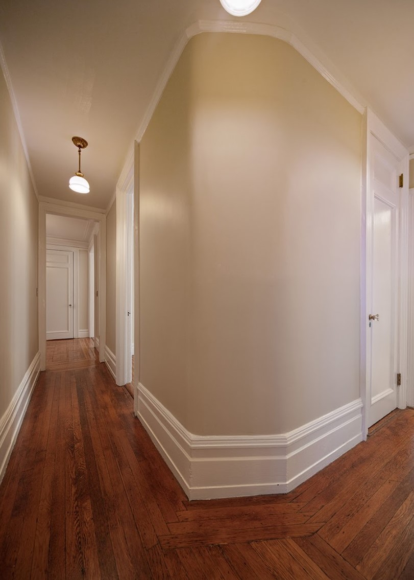 Before: A long corridor extends straight ahead, a door is in the distance. To the right, there is a small closet door.