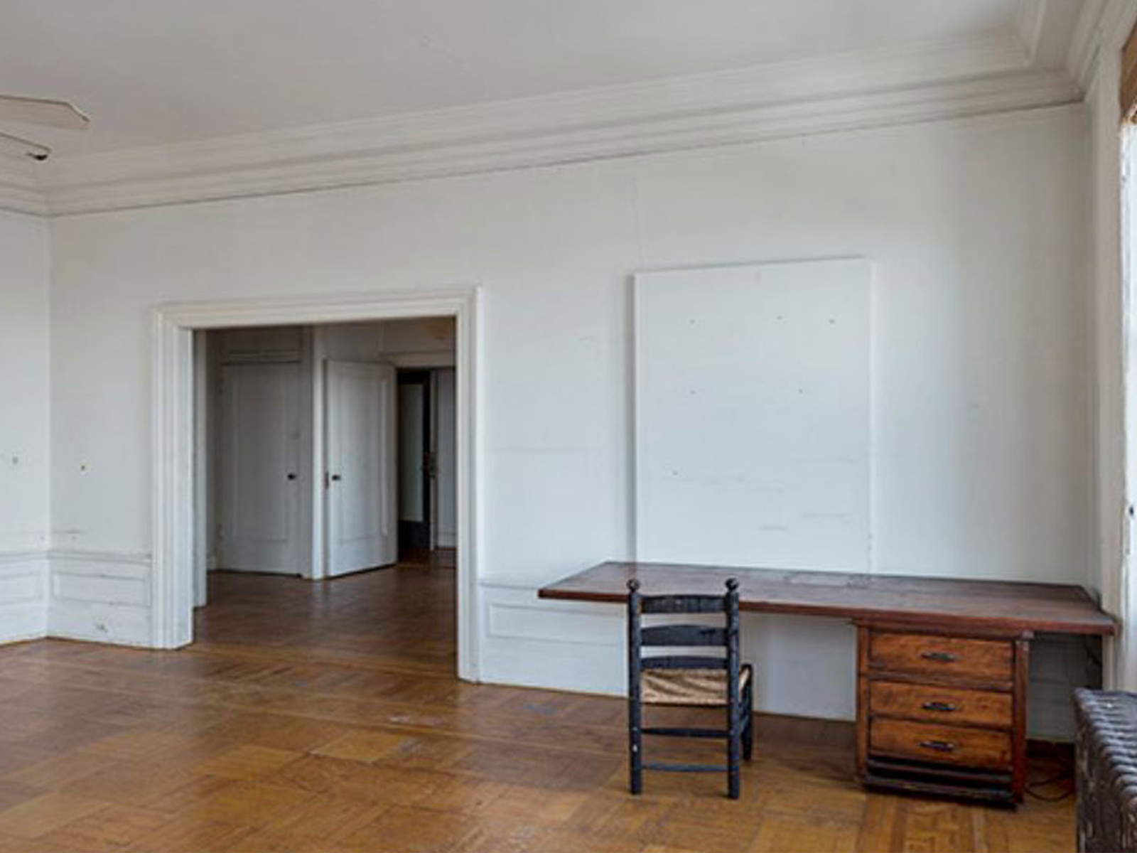 A large room with a large window and one small door