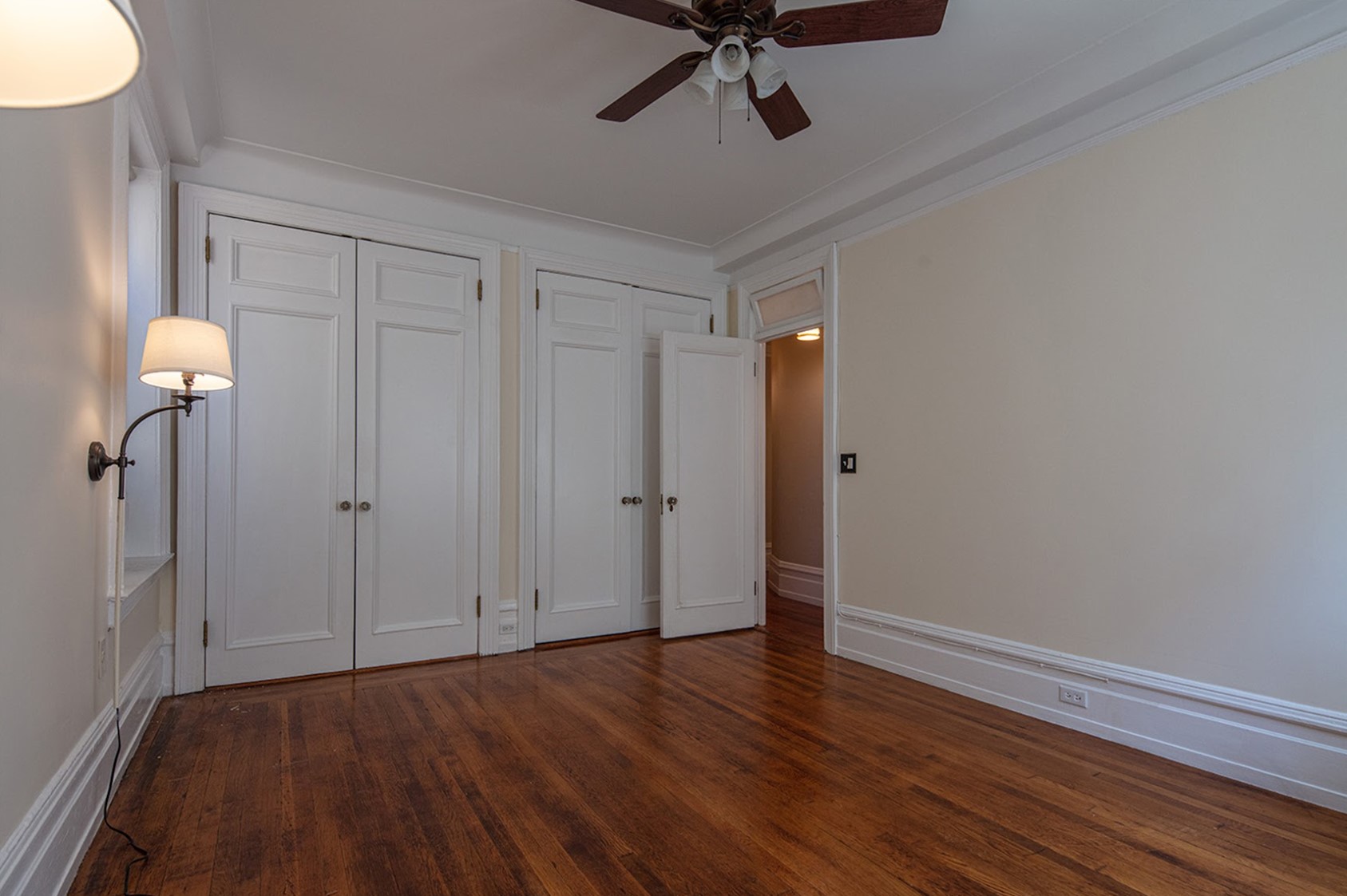 Before: An unfurnished Prime Bedroom with a wall of closets straight ahead, the entry to the room is on the long wall.