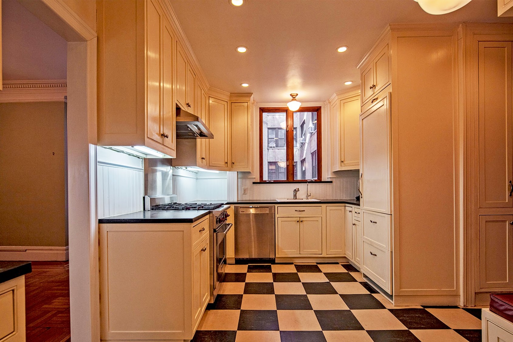 Before: The Kitchen looks narrow with the stove on the left and a sink in front of a single window.